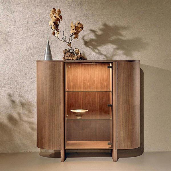 DUSK SIDEBOARD Dusk sideboard blends form and function with sculptural elegance. Its base flows into the wooden doors, creating a sense of movement and continuity. Topped in your choice of marble, wood, or ceramic, Dusk brings refined creativity to any space